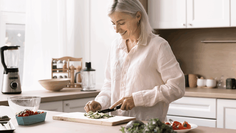 Woman preparing a home-cooked meal in her kitchen after working on a proactive health plan at Health for Life Naturopathic Clinic in Phoenix, AZ.