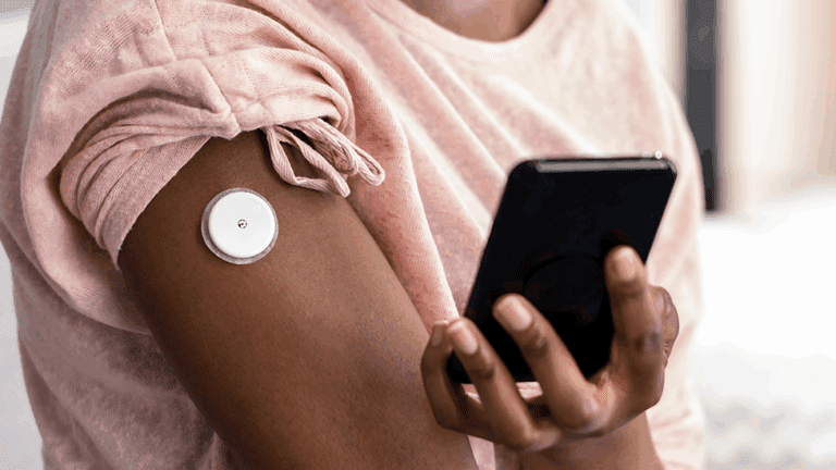 A woman monitoring her blood sugar with a continuous glucose monitor, provided by Health for Life Naturopathic Clinic in North Scottsdale, AZ