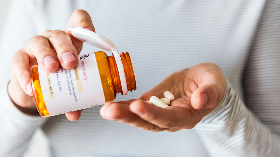 A person taking their prescription medication that was prescribed by naturopathic doctor at Health for Life Naturopathic Medicine Phoenix, AZ