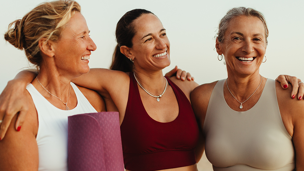 A group of middle-aged women in athletic clothing enjoying each other's company and being active together.