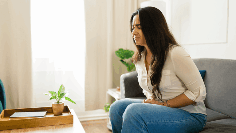 Woman experiencing pain and discomfort in her abdomen from SIBO.