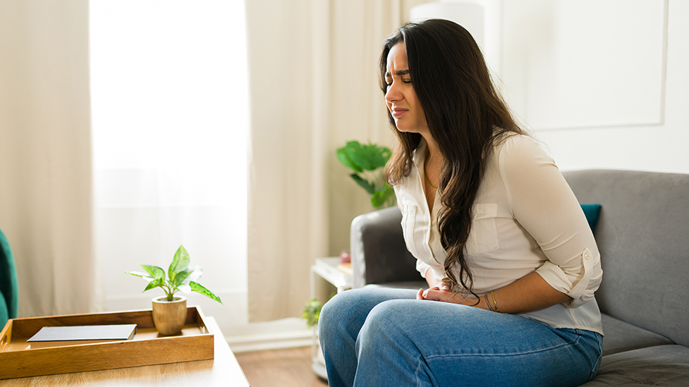 Woman experiencing pain and discomfort in her abdomen from SIBO.