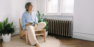 Relaxed older woman enjoying a green smoothie, representing healthy aging and wellness supported by peptide therapy in Scottsdale.