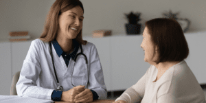 Practitioner explaining the difference between a holistic doctor, functional medicine, and naturopathic medicine to a patient during a consultation.