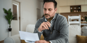 Man reviewing his blood test results at home after receiving elevated alkaline phosphatase lab results.
