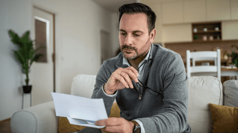 Man reviewing his blood test results at home after receiving elevated alkaline phosphatase lab results.