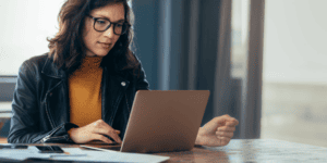 Woman relaxing at home with a warm drink, representing calm focus and relief from brain fog