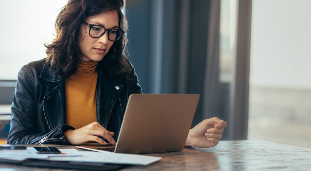 Woman relaxing at home with a warm drink, representing calm focus and relief from brain fog