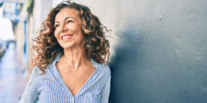 Woman smiling and looking outward, representing hormone health support for women in Scottsdale, AZ