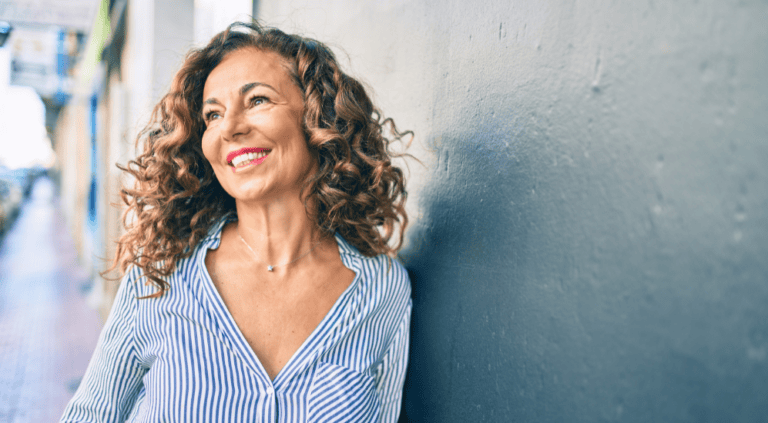 Woman smiling and looking outward, representing hormone health support for women in Scottsdale, AZ