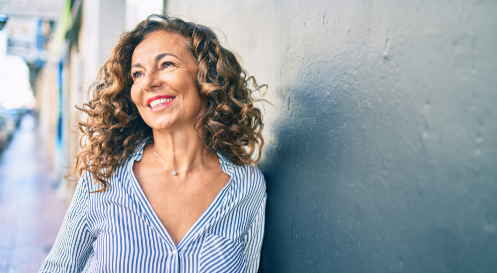 Woman smiling and looking outward, representing hormone health support for women in Scottsdale, AZ
